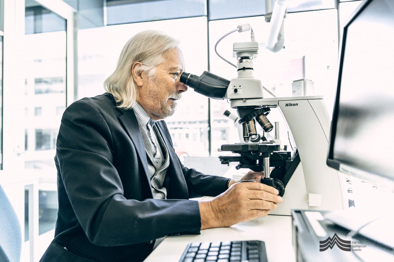 Professor Gustaaf Hallegraeff looking through a microscope